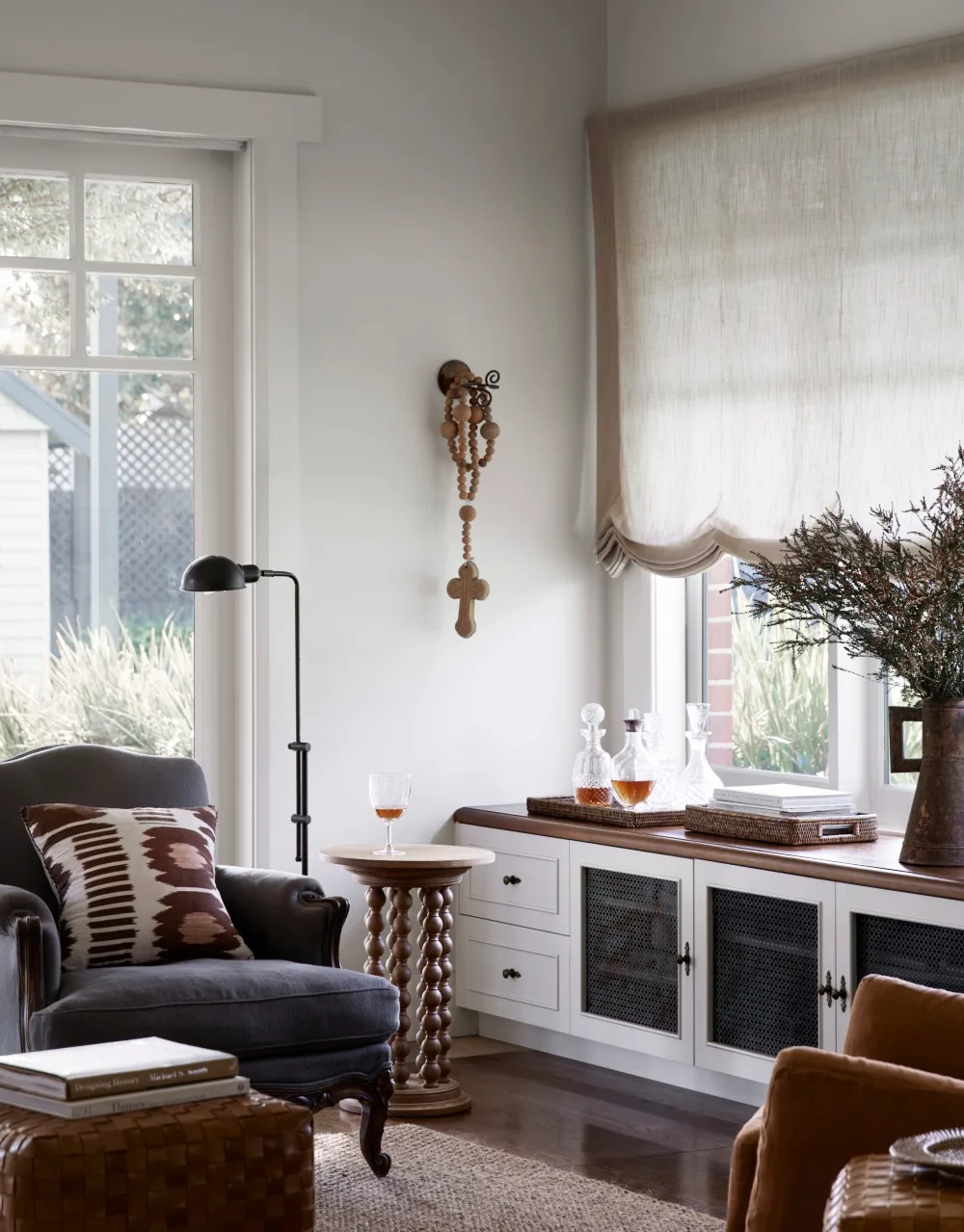 Cottage living room with Austrian blinds and build in cabinetry