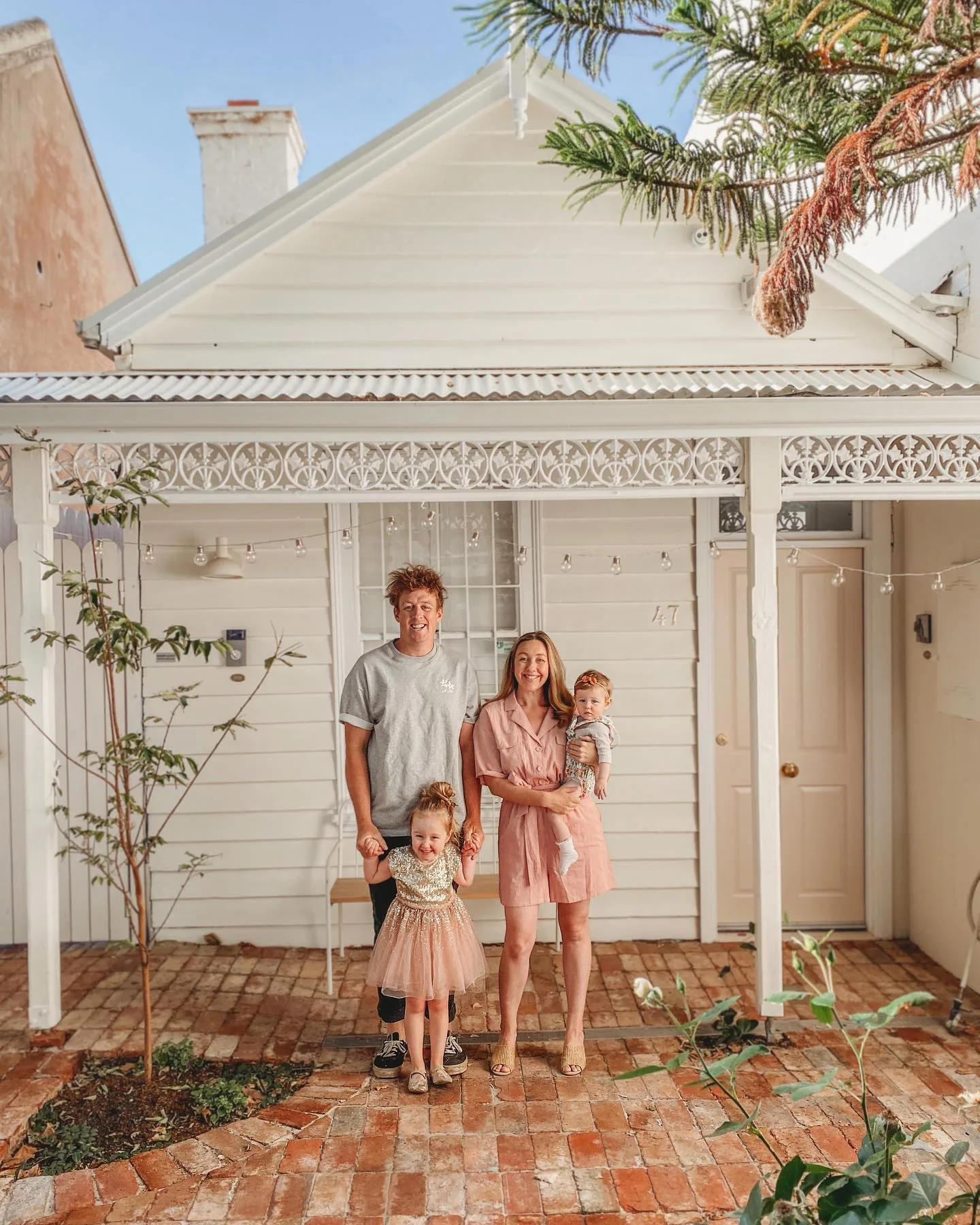 Josh and Jenna with their family outside of their award-winning Melbourne home.