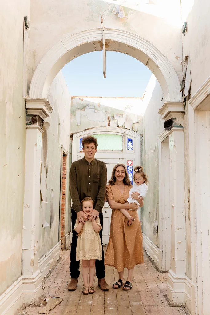 Professional renovators Josh and Jenna Densten with their children in a hallway of a heritage home in Rutherglen, VIC.