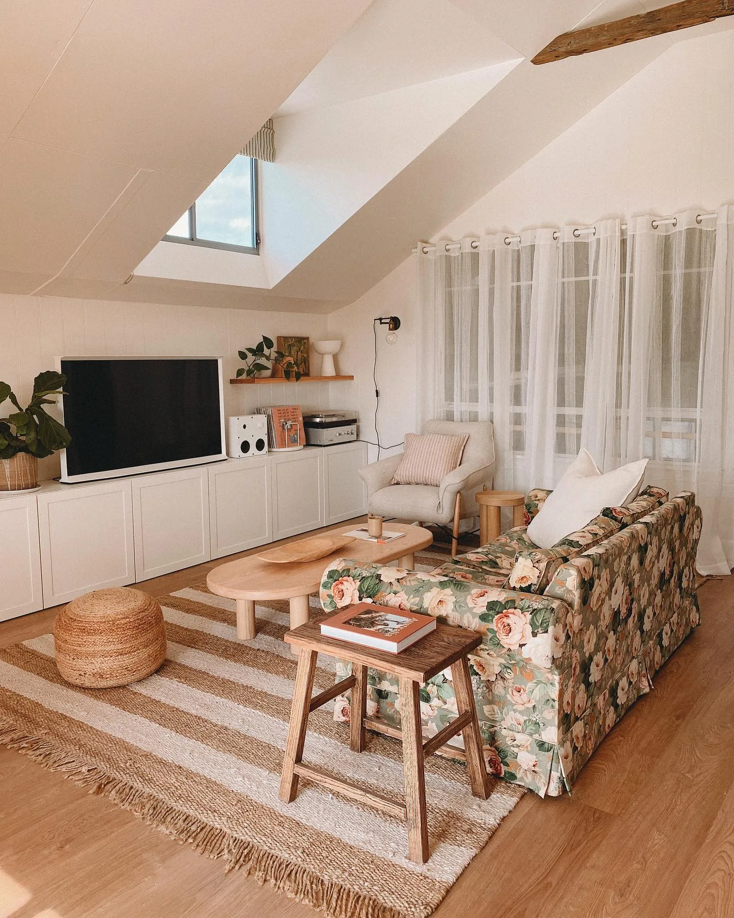 Neutral and floral living room inside Josh and Jenna's shed house in Rutherglen, VIC.
