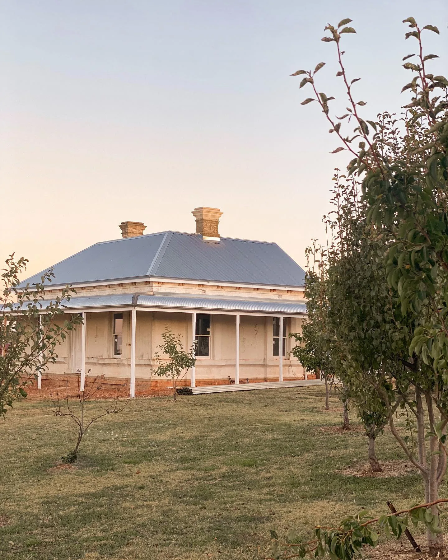 Exterior of Josh and Jenna's Rutherglen homestead, featuring a brand new roofing and a bullnose verandah.