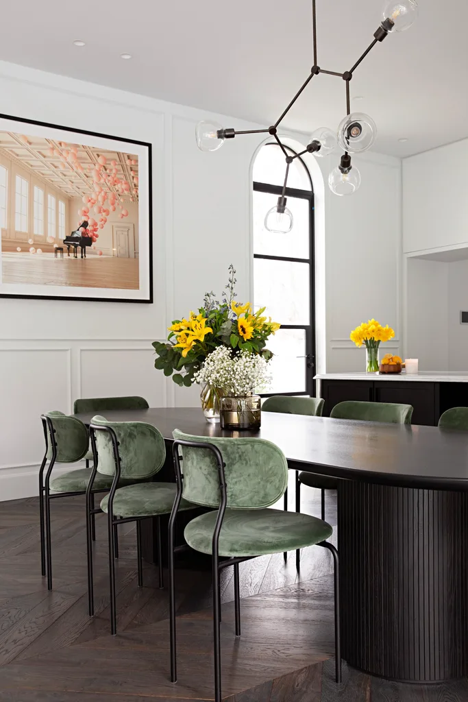 Sam and Snezana Wood home dining room with oval table and dark timber parquetry flooring