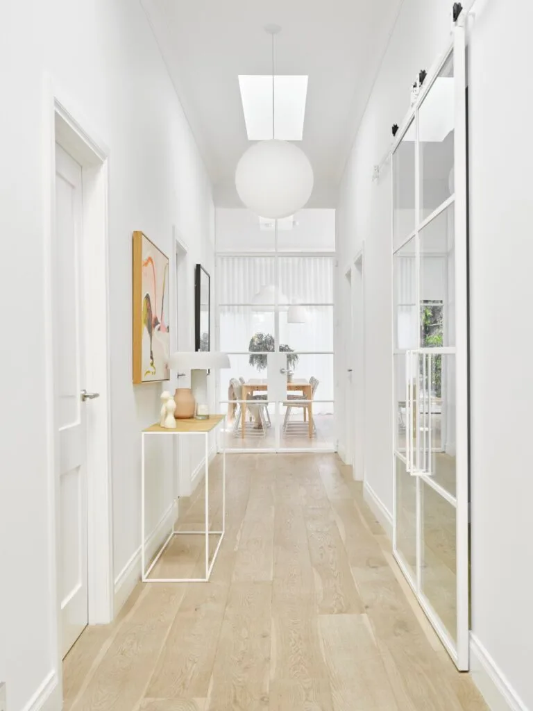 White renovated hallway and glass sliding doors.