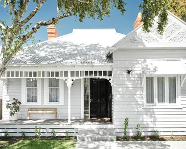 Renovated white Victorian cottage facade.