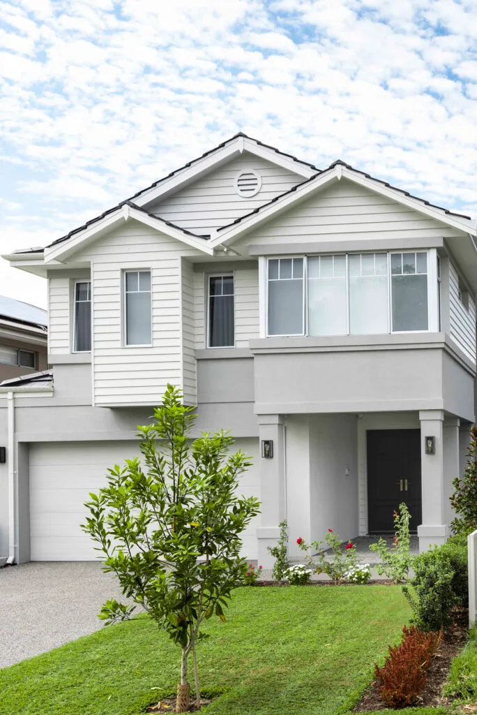 Elegant Perth Hamptons-style home with white and grey facade. 