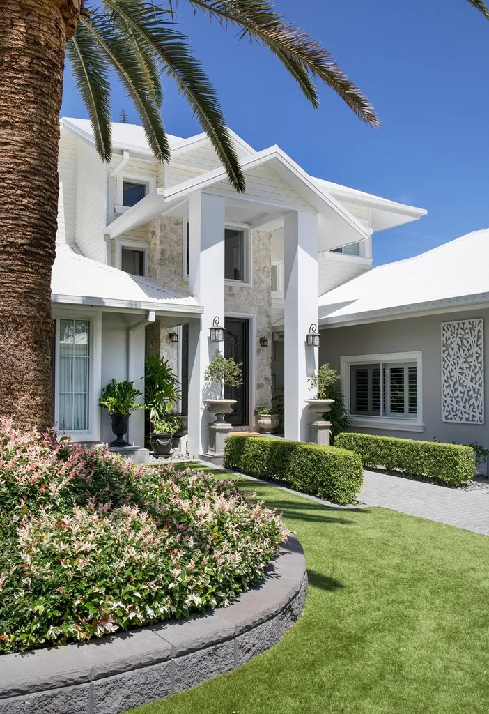 Modern Hamptons home with stone front entrance and garden.