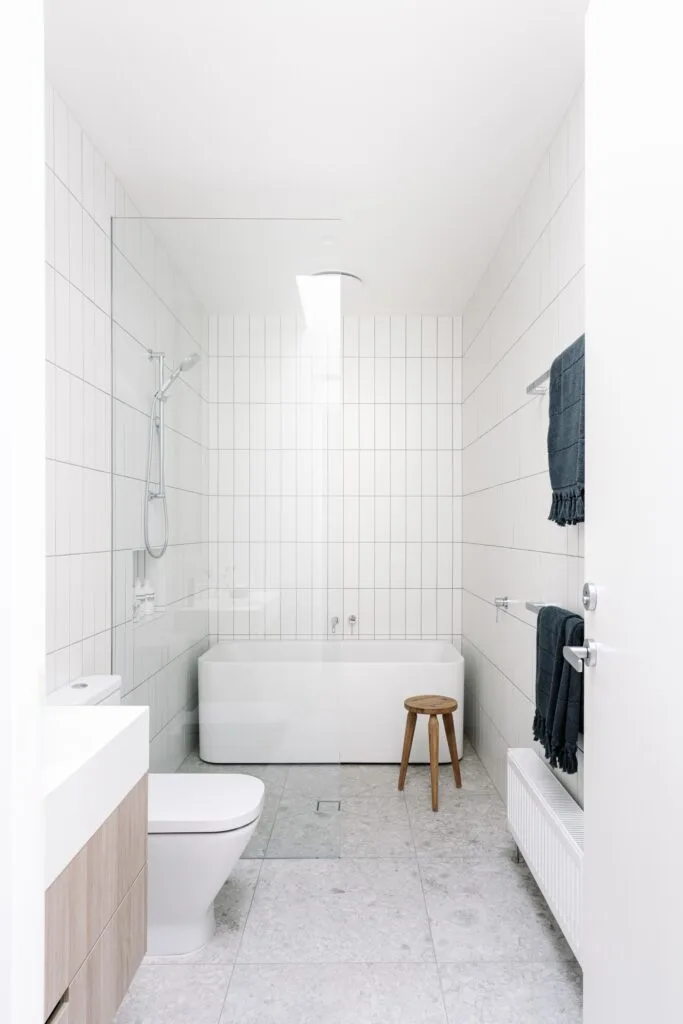 White tiled bathroom and freestanding bath.