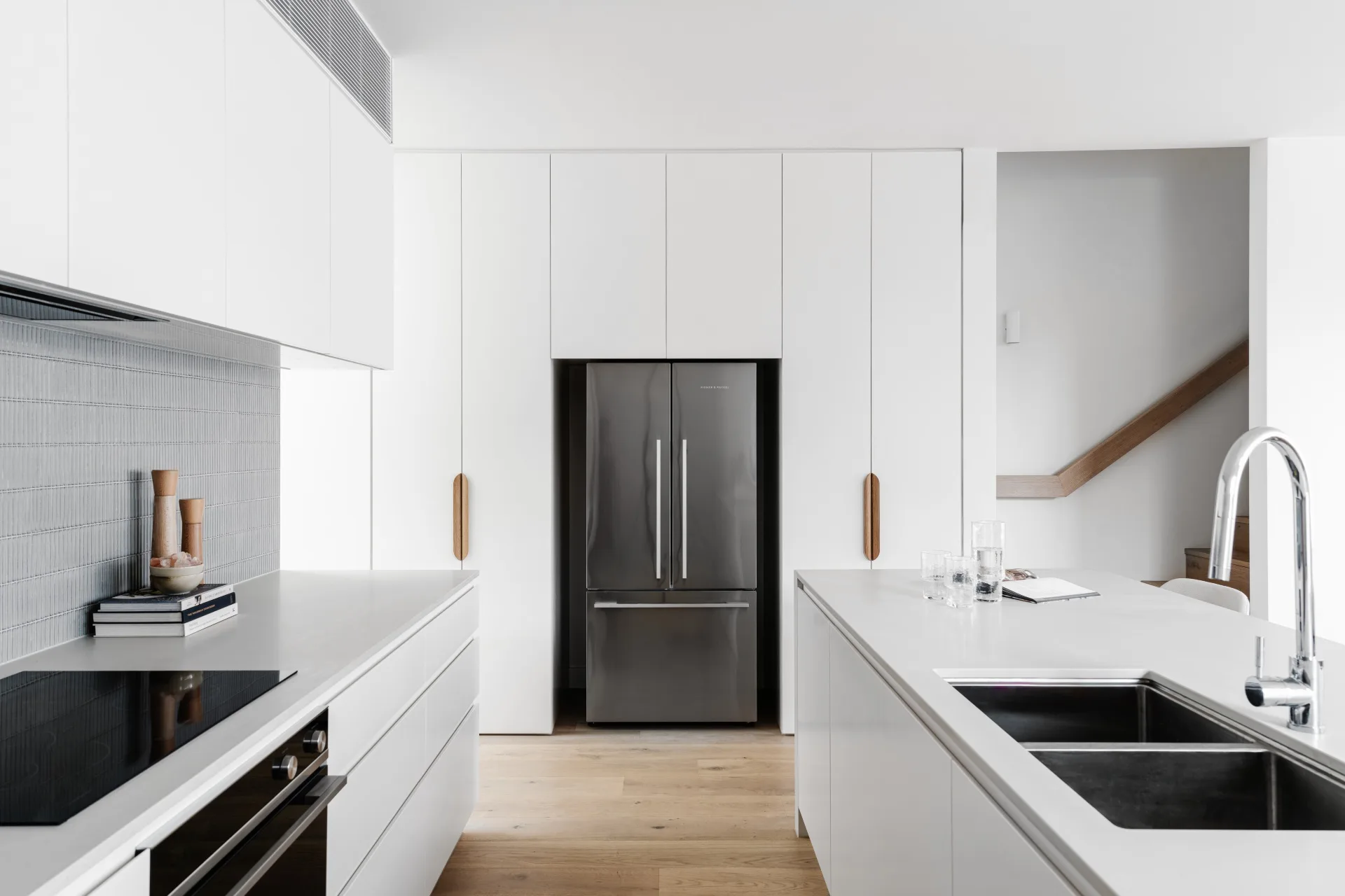 Contemporary white kitchen and finger tile splashback.