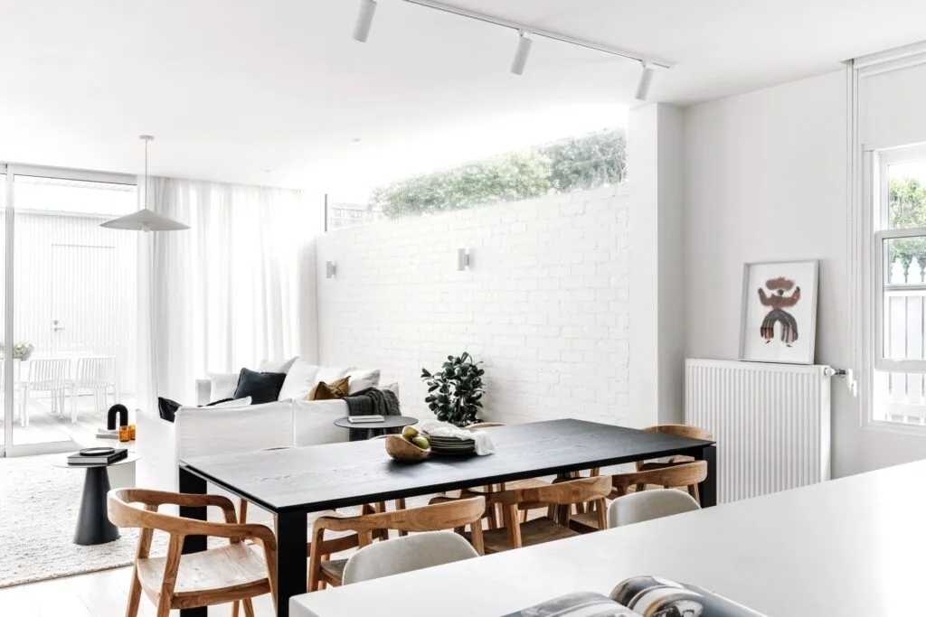 Living room white painted brick and clerestory windows.