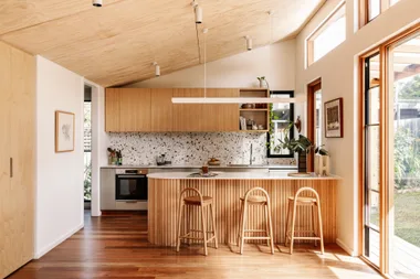 Sustainable timber kitchen with fluted timber island and clerestory windows.