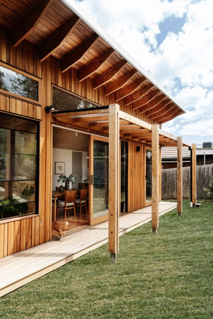 Outdoor deck with reclaimed timber cladding and pergola.