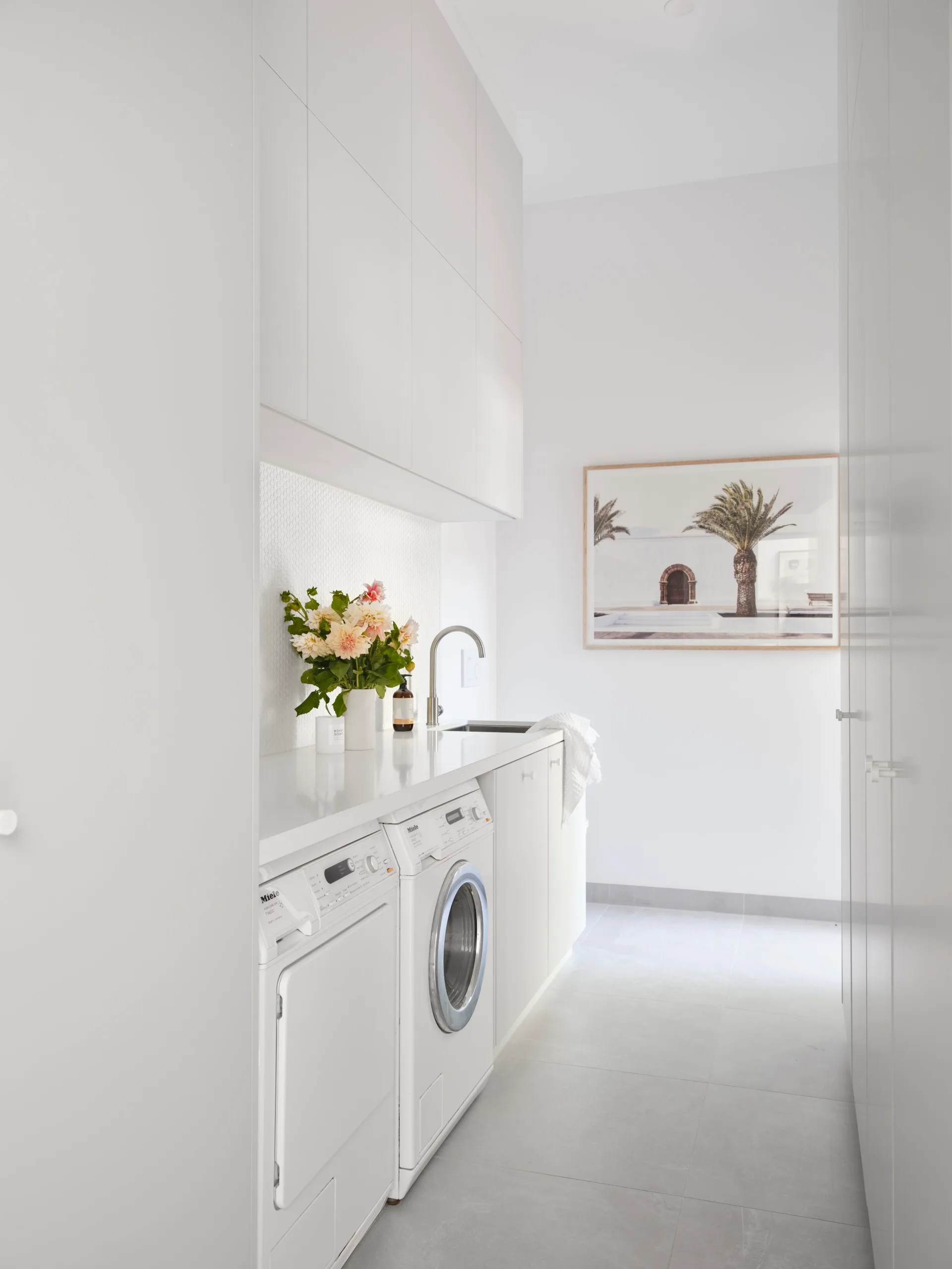 Renovated white laundry room.