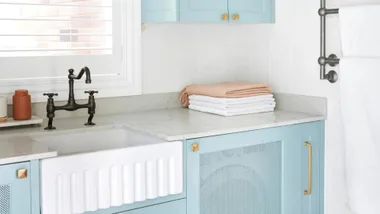 Blue and white laundry with brass and nickel finishes.