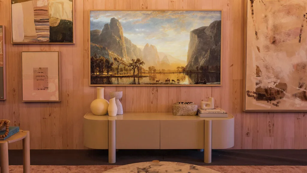 Samsung The Frame television hung above a timber console in a gallery-wall style.