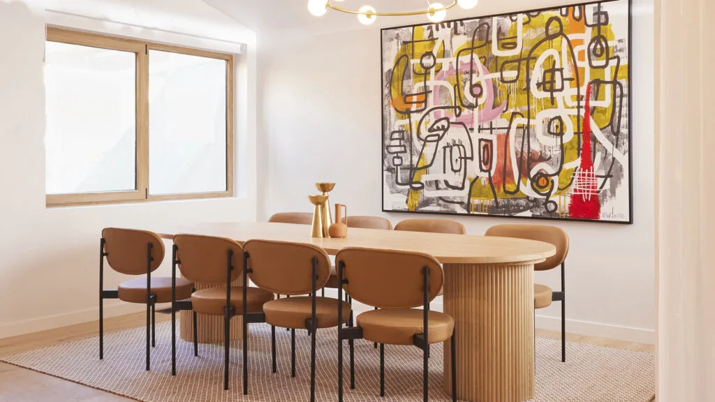 Minimal dining room with timber dining table and colourful artwork from The Block 2023 House 5.