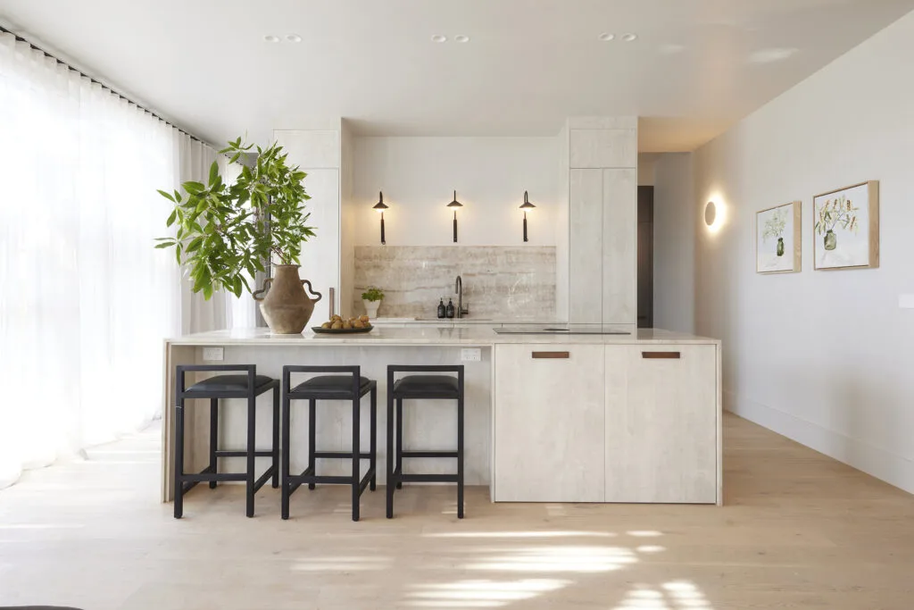 Japandi style kitchen with marble kitchen benchtop and trio of statement wall lights.