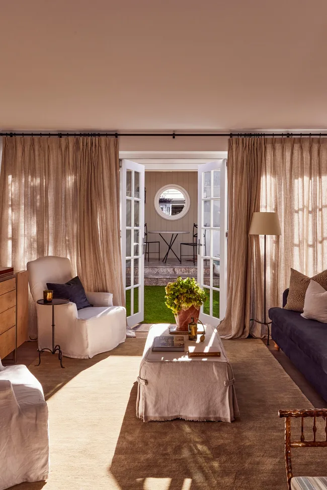 Floor to ceiling curtains frame the contemporary living area opening to the backyard.