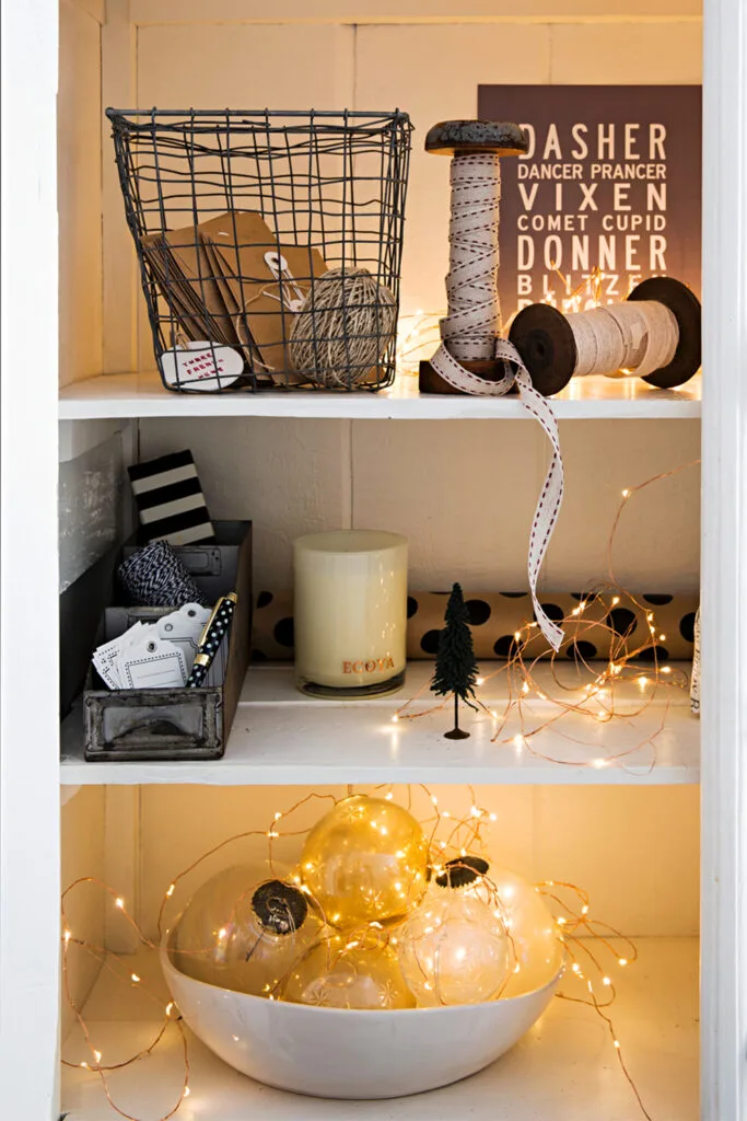 Rustic timber recessed shelf styled with fairy lights and Christmas baubles