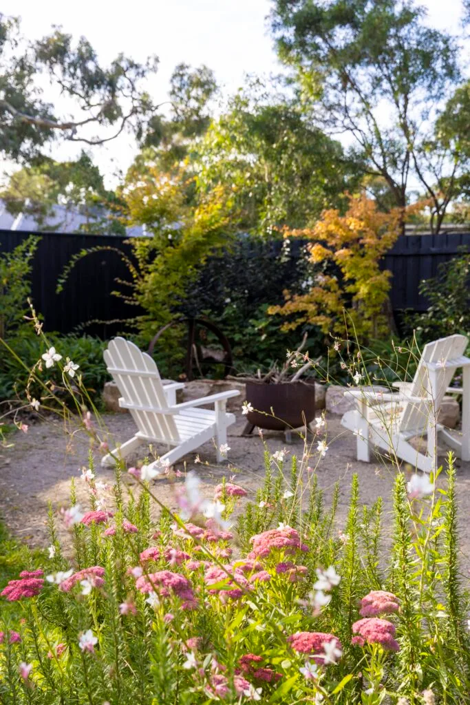 Fire pit and pink and white cottage flowers.