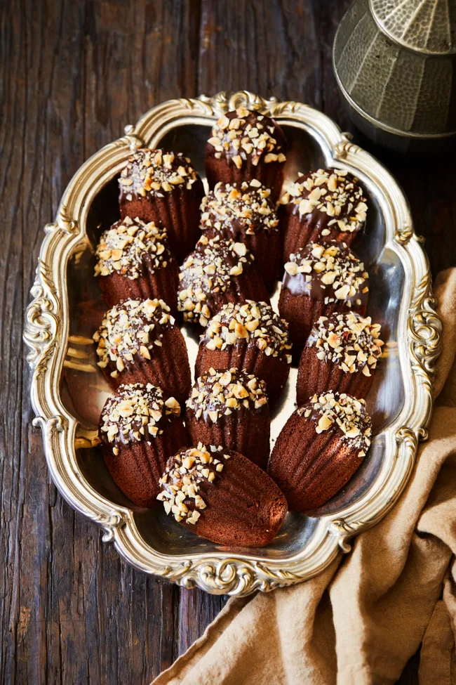 Chocolate hazelnut madeleines on a tray.