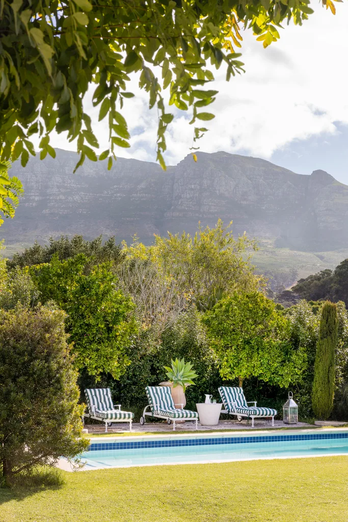 Garden and pool with mountains in background.