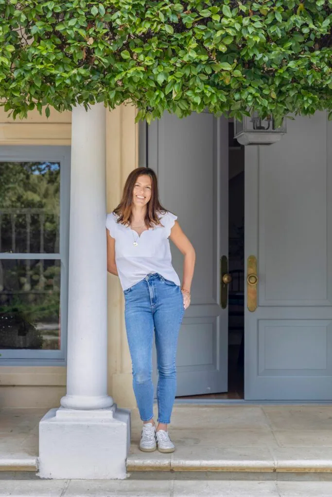 Portrait of homeowner Lauren standing at the entrance.