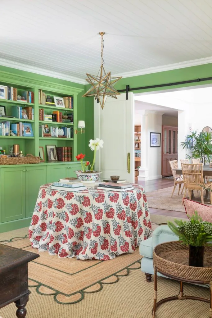 Library reading nook in green with table and star light pendant.