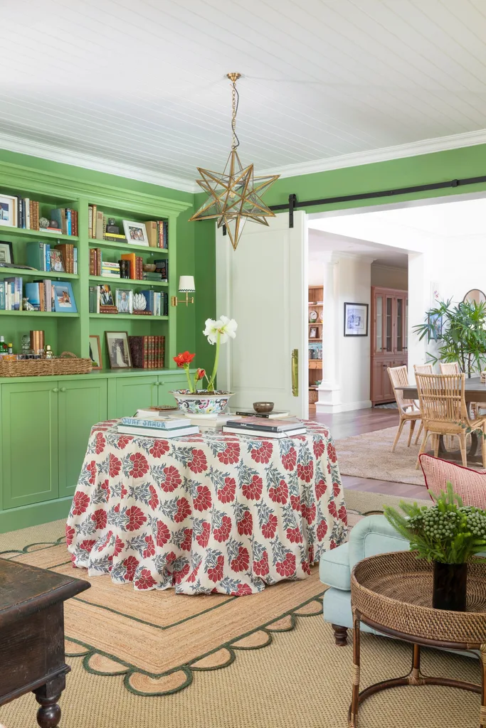 Library reading nook in green with table and star light pendant.