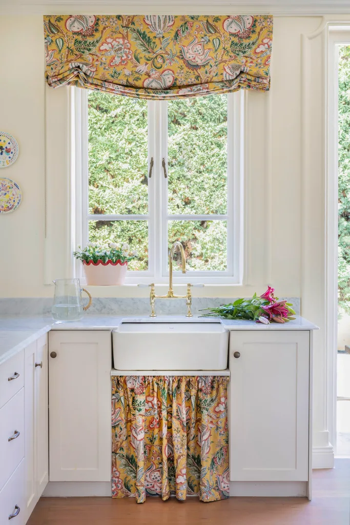 Butler's sink and yellow patterned curtains.