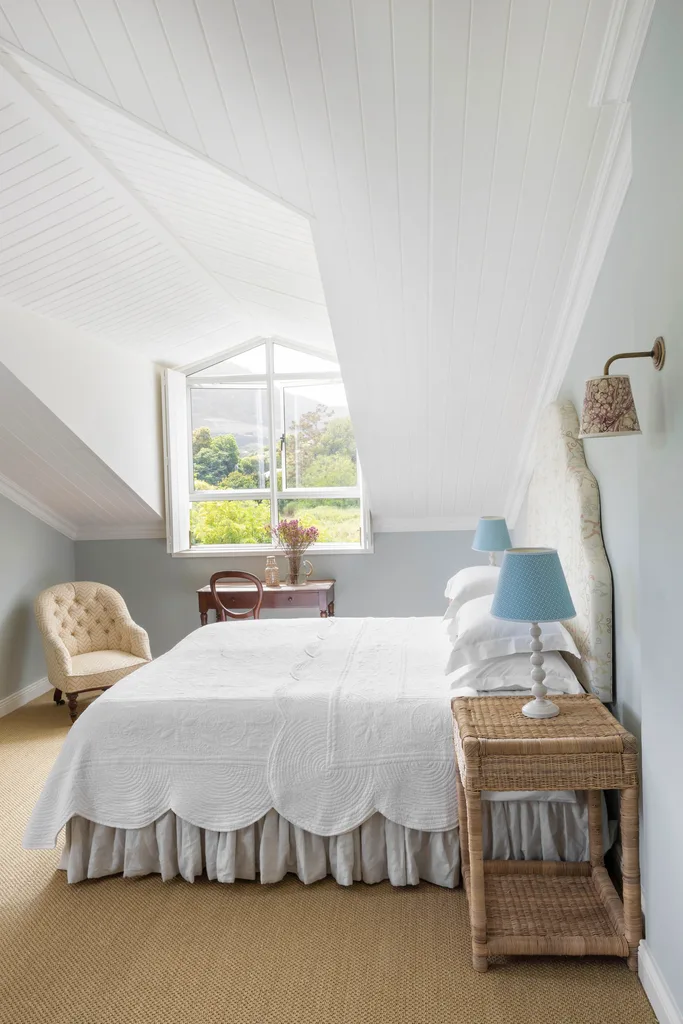 All-white classical English guest bedroom with raised roof.