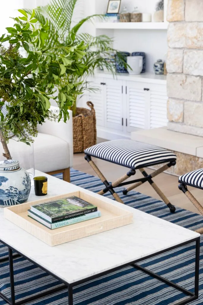 Marble coffee table and striped coastal living room chairs.