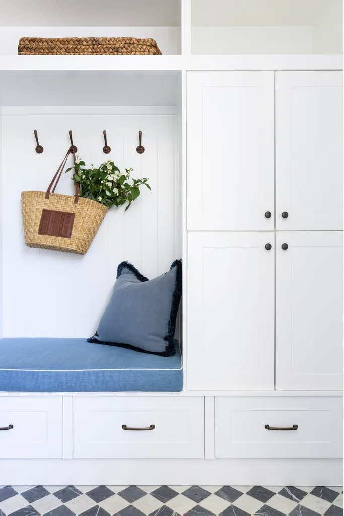 Contemporary coastal mudroom cupboards and blue seat.