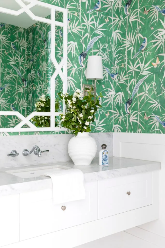 Powder room with green bamboo wallpaper.