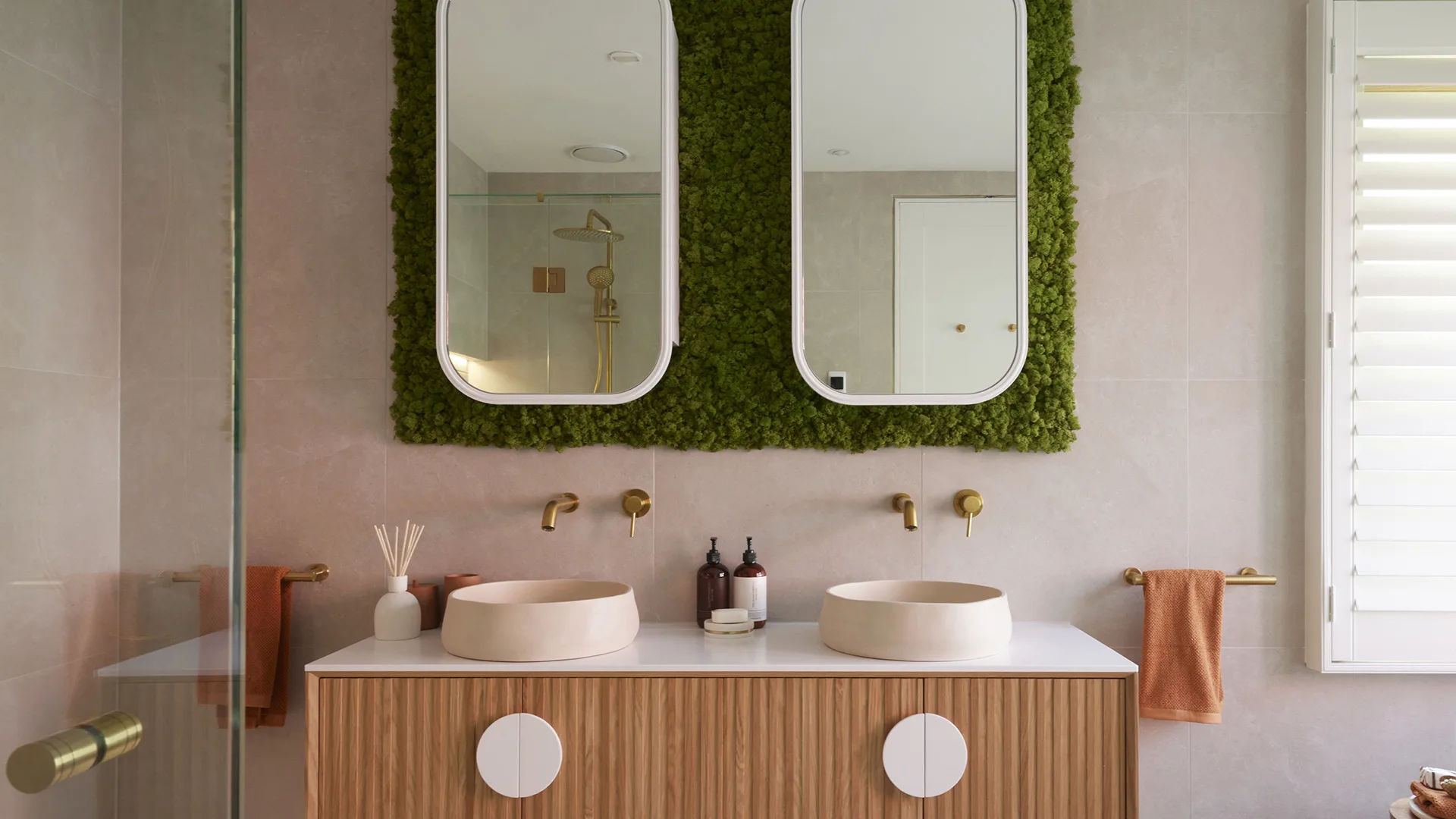 Contemporary bathroom with moss feature wall above vanity.