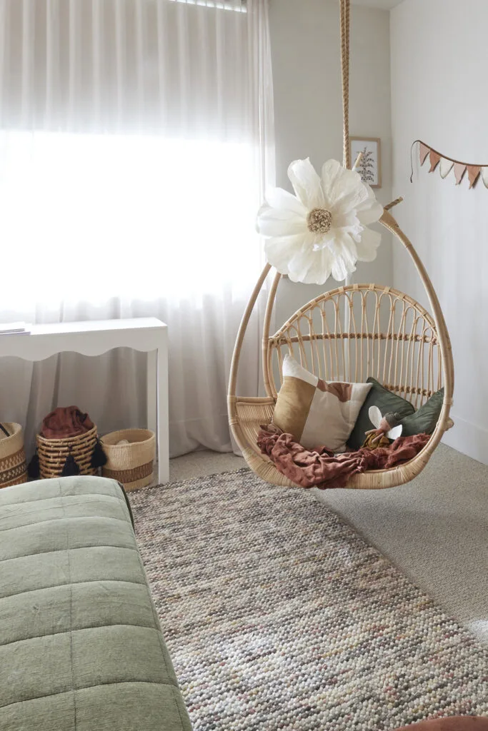 Hanging egg chair in a neutral Japandi style kids' or teen bedroom