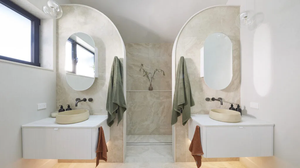 Contemporary bathroom design with symmetrical arches and double shower.