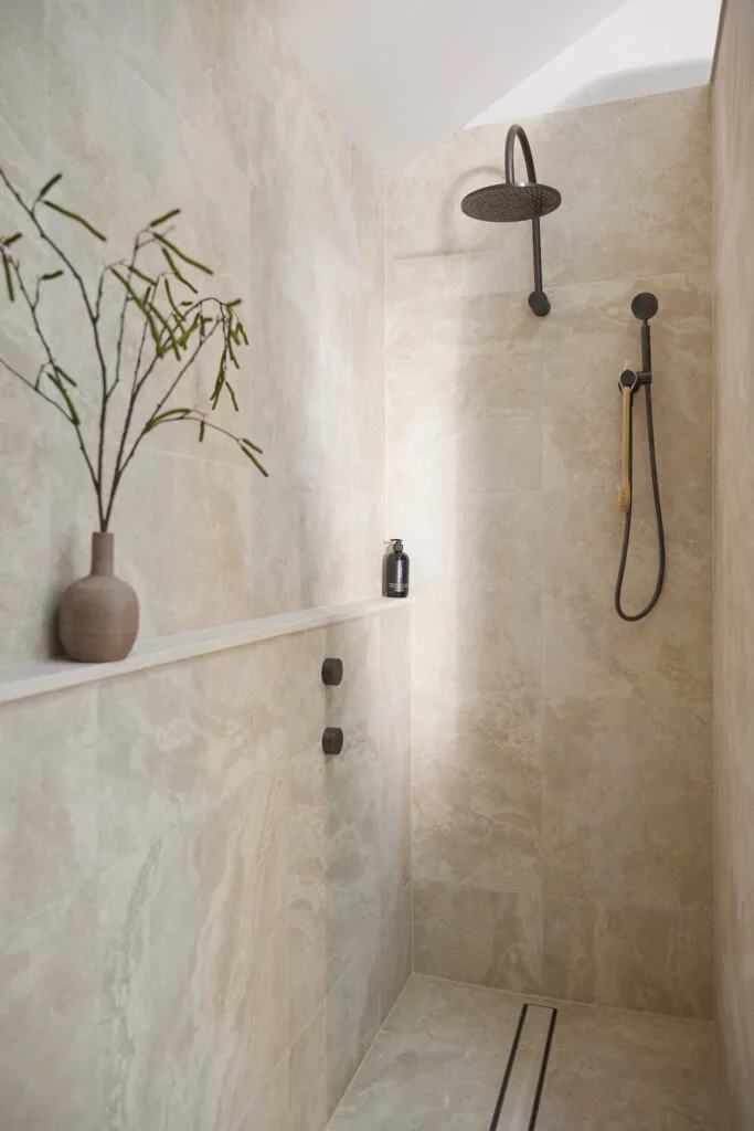 Contemporary shower design with ledge shelf.