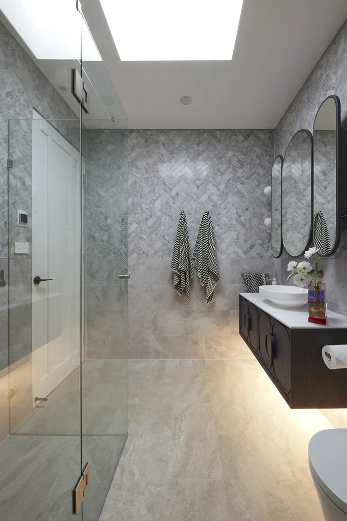 Modern marble bathroom with floating timber vanity.
