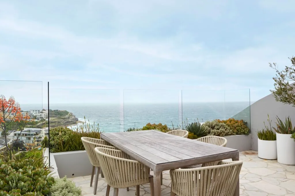 Balcony outdoor dining overlooking the ocean.