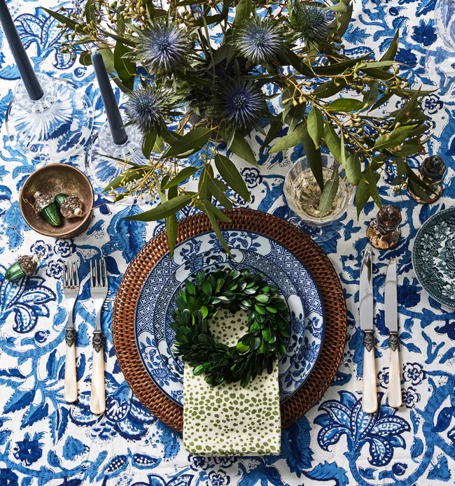Blue and white table setting with a vase of flowers