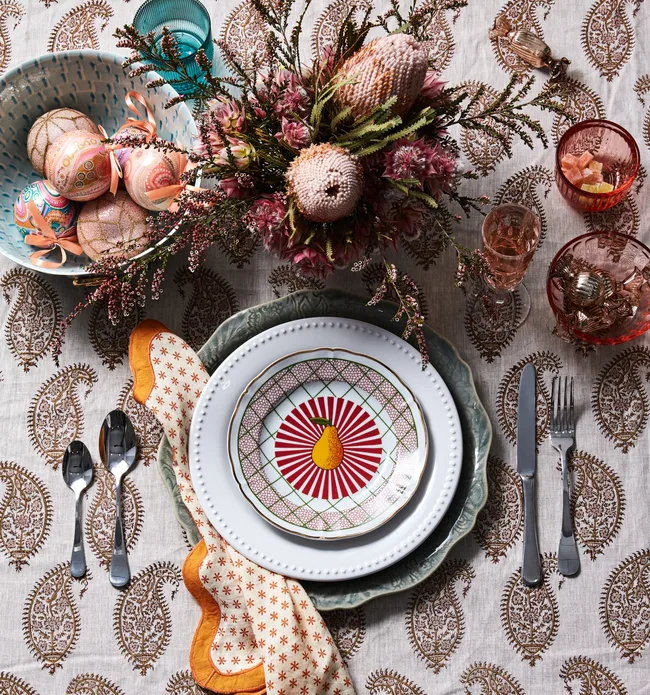 Colourful table setting with lots of native plants and a bowl of Christmas baubles