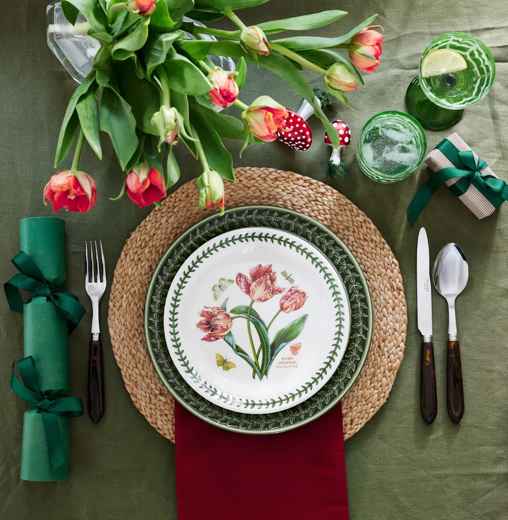 Christmas table decorations with green table linen, tulips and a green bon-bon