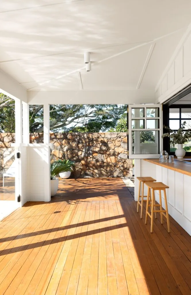 A timber deck and alfresco dining area beside the pool.