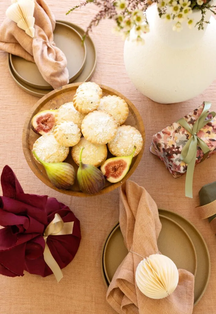 A neutral tablescape with figs and florals.