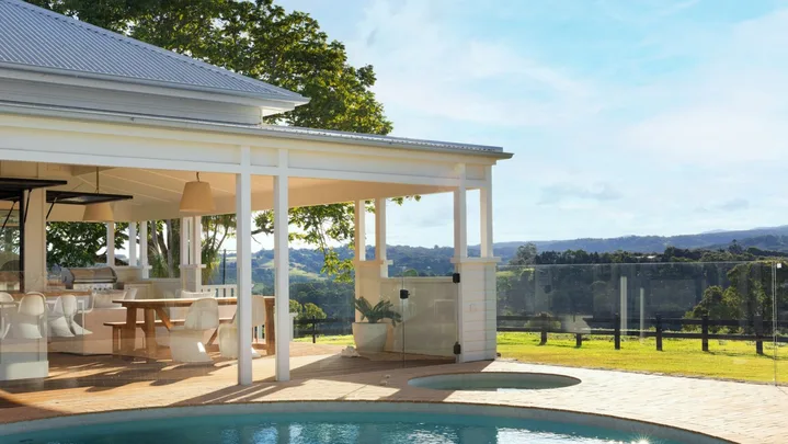 A modern country style home with an outdoor pool and spa.