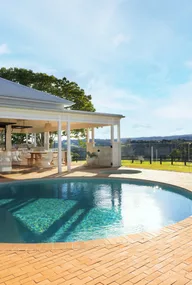 A modern country style home with an outdoor pool and spa.