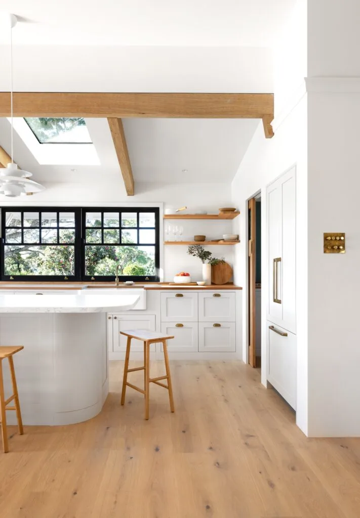 Modern country kitchen with rosewood timber accents and a marble island bench.