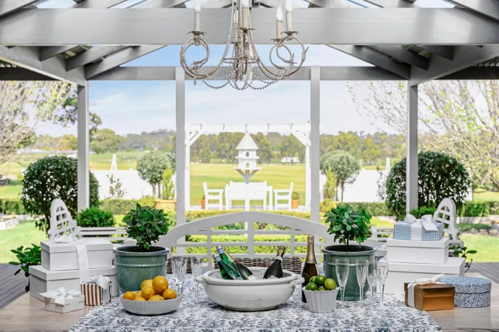 The outdoor alfresco dining area with a classic blue and white table setting.