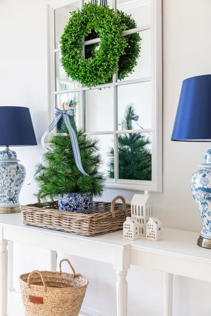 A wreath and miniature Christmas tree on the entrance console.