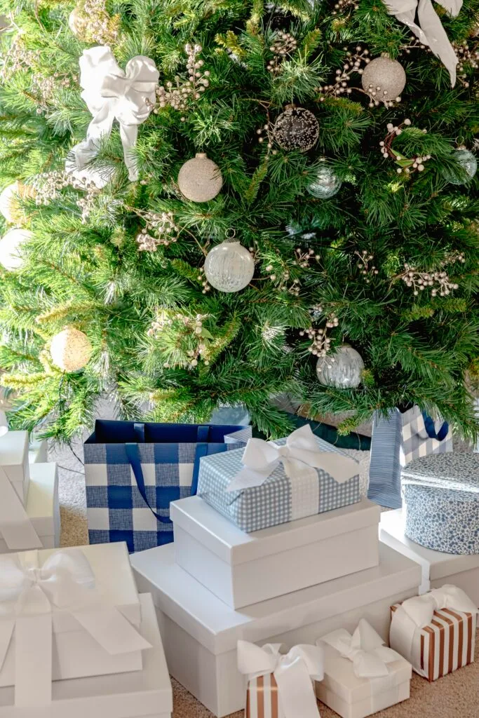 Blue and white Christmas presents under the tree.